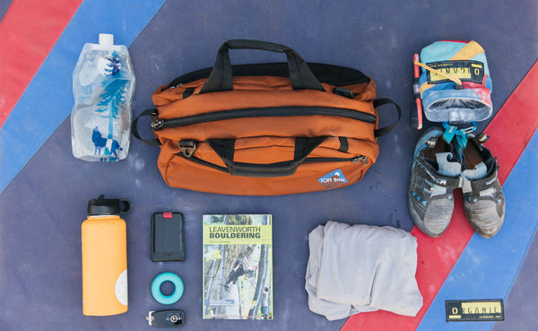 Old School Carry-All in Burnt Orange with climbing gear around it.